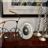 D13. Model tricycle, Tara picture frame and metal candlesticks.